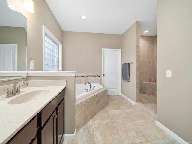 bathroom featuring shower with separate bathtub and vanity