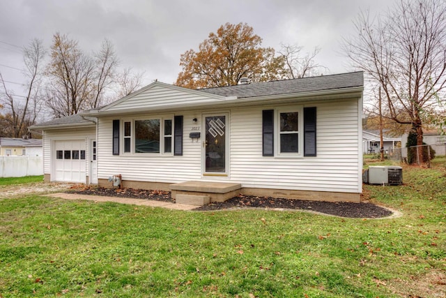 single story home featuring a garage, a front lawn, and central air condition unit