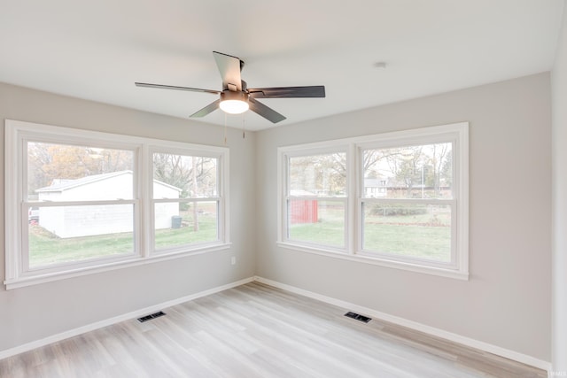 spare room with ceiling fan and light hardwood / wood-style flooring