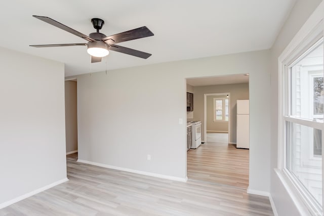 unfurnished room with ceiling fan and light wood-type flooring