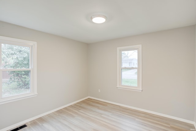 spare room featuring light hardwood / wood-style floors