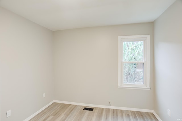 unfurnished room with wood-type flooring