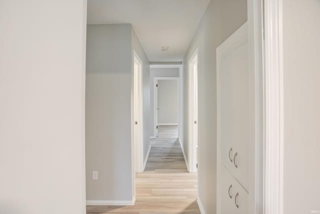 hall with light hardwood / wood-style flooring