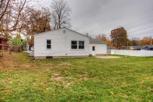 rear view of property with a lawn and a patio area