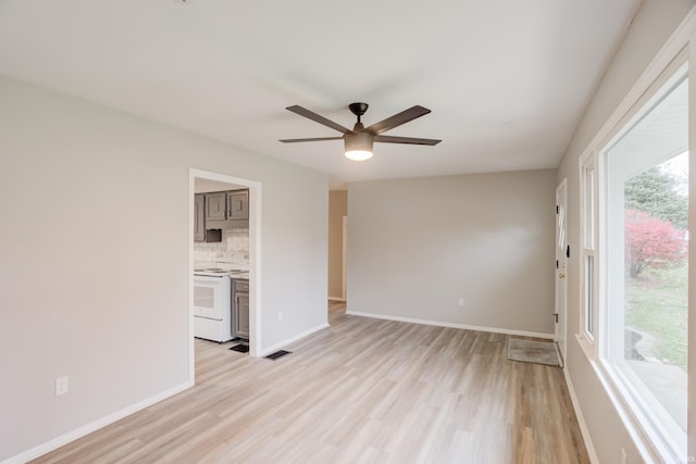 unfurnished living room with light hardwood / wood-style flooring and ceiling fan