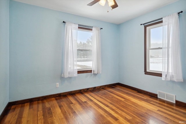 unfurnished room with ceiling fan and wood-type flooring