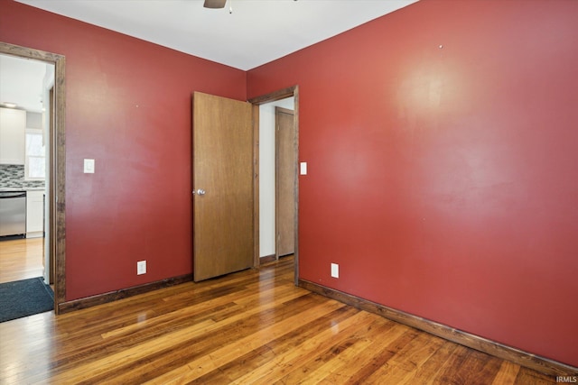 empty room with ceiling fan and wood-type flooring