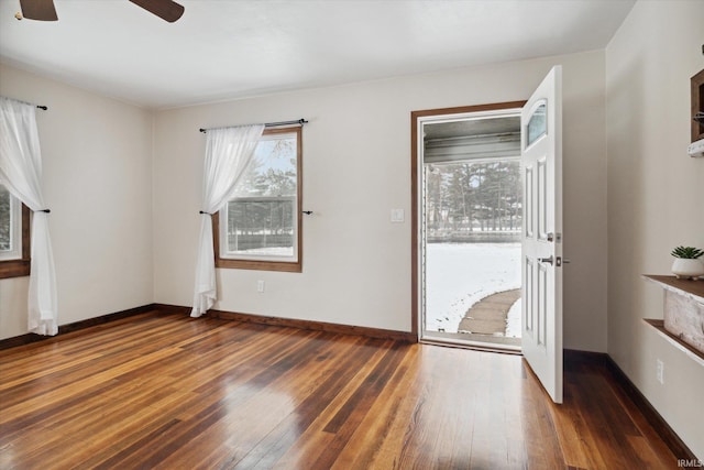 interior space with ceiling fan and dark wood-type flooring