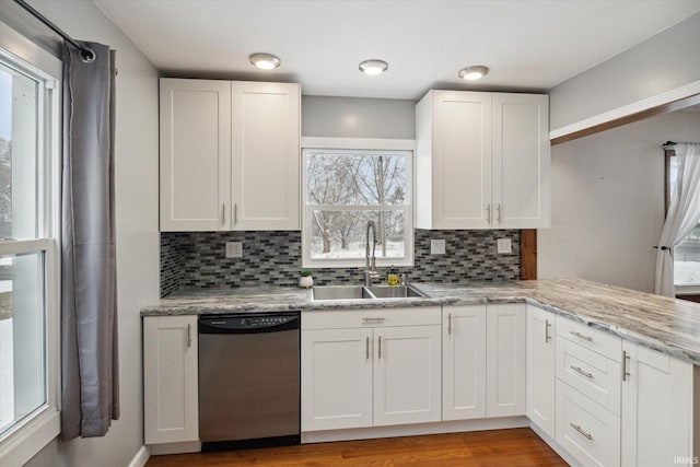 kitchen featuring dishwasher, white cabinets, and tasteful backsplash