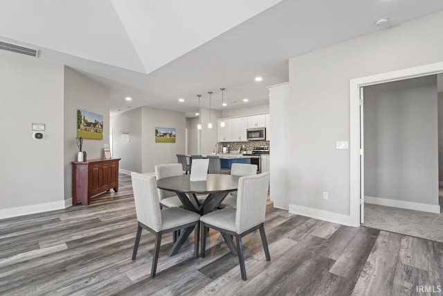 dining space with dark wood-type flooring