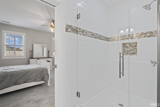 bathroom with a shower with door and ceiling fan