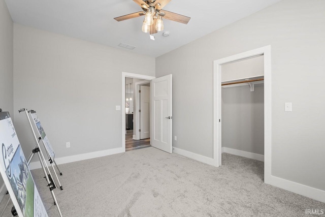 unfurnished bedroom with ceiling fan, light carpet, and a closet