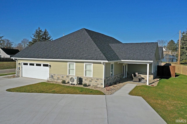 view of front facade featuring ac unit, a garage, and a front yard