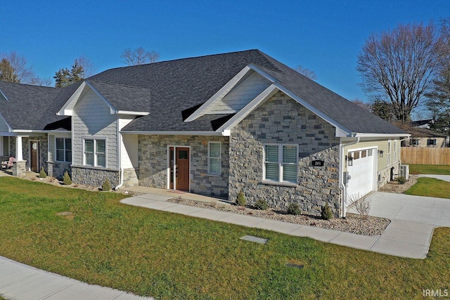 craftsman house featuring a garage and a front lawn