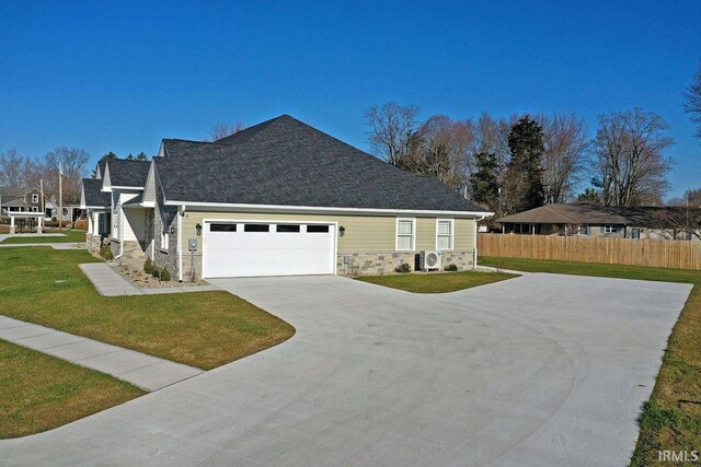 view of front facade with ac unit, a front lawn, and a garage