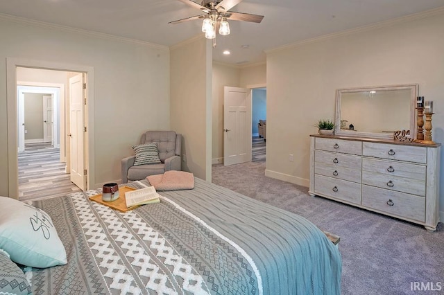 bedroom featuring light colored carpet, ceiling fan, and crown molding