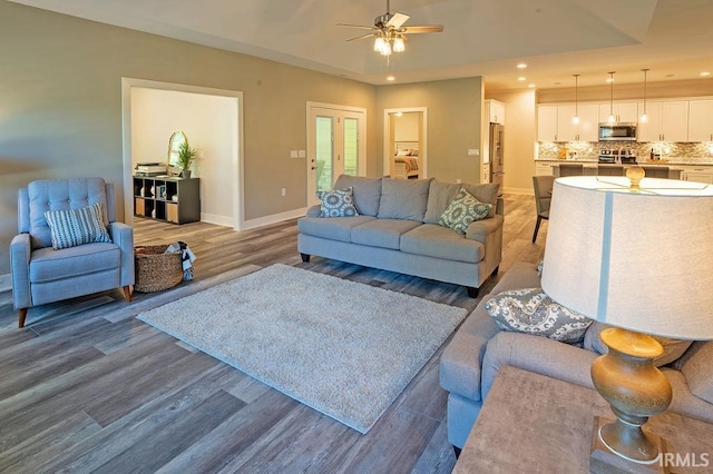 living room featuring ceiling fan and hardwood / wood-style floors