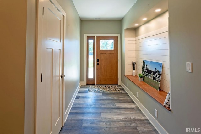 entryway with dark hardwood / wood-style flooring