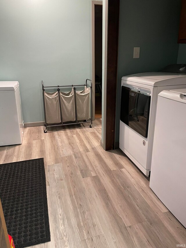 washroom featuring washer and dryer and light wood-type flooring