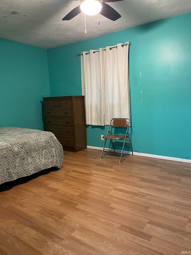 bedroom with light hardwood / wood-style flooring and ceiling fan