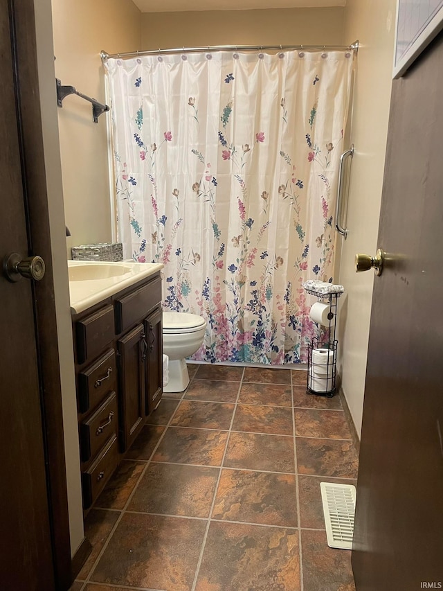 bathroom featuring vanity and toilet