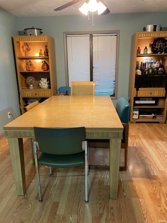 dining space with hardwood / wood-style flooring and ceiling fan