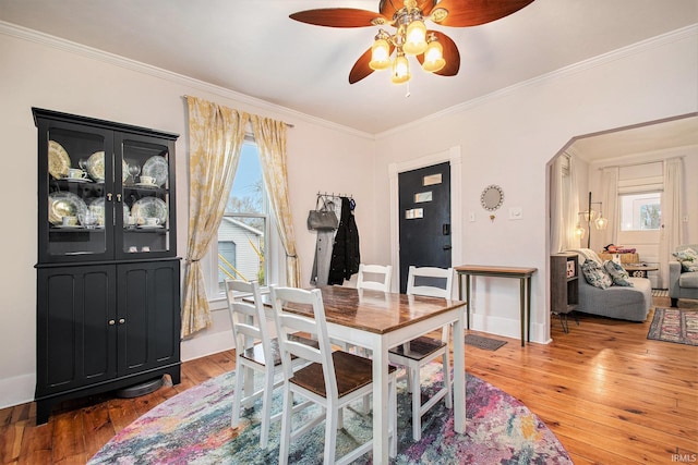 dining area featuring hardwood / wood-style floors, ceiling fan, a healthy amount of sunlight, and ornamental molding