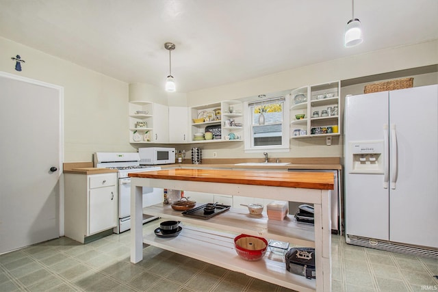 kitchen with white cabinetry, wooden counters, pendant lighting, and white appliances