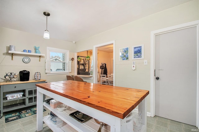 kitchen featuring pendant lighting and wood counters