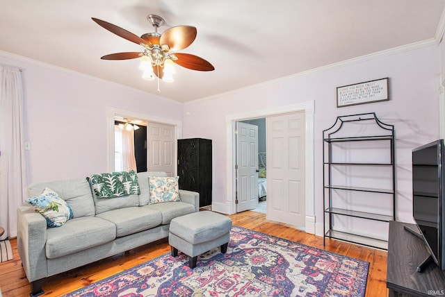 living room with ceiling fan, light hardwood / wood-style flooring, and ornamental molding