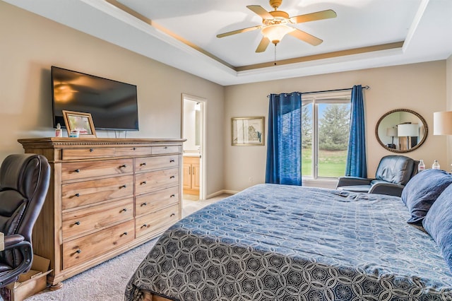 carpeted bedroom featuring ensuite bathroom, ceiling fan, and a raised ceiling