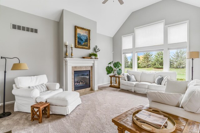 carpeted living room with ceiling fan, lofted ceiling, and a fireplace