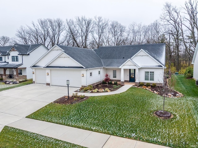 view of front of home with a garage and a front lawn