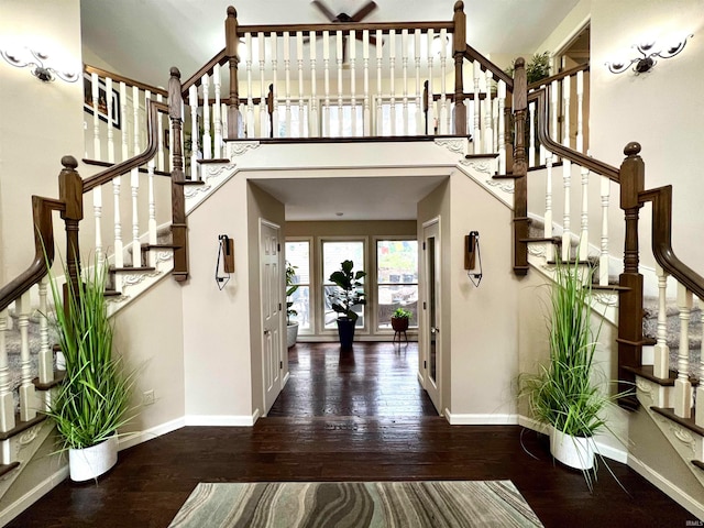 entrance foyer with baseboards, stairway, and hardwood / wood-style floors