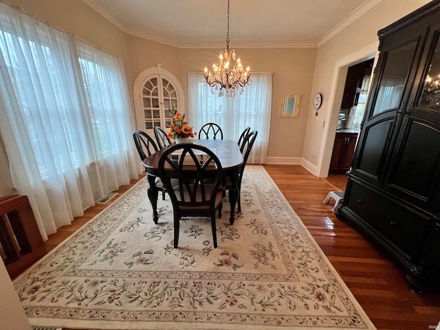 dining room featuring a notable chandelier, dark hardwood / wood-style floors, and crown molding