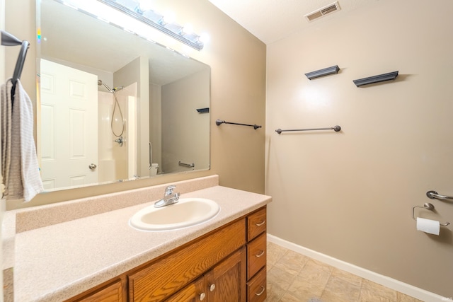 bathroom with walk in shower, vanity, and toilet