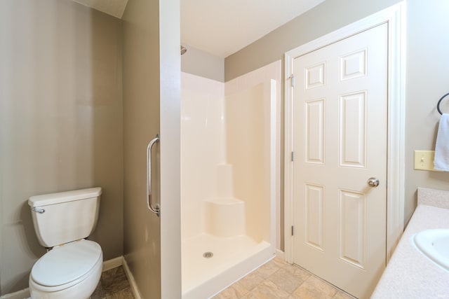 bathroom with tile patterned floors, a shower, vanity, and toilet