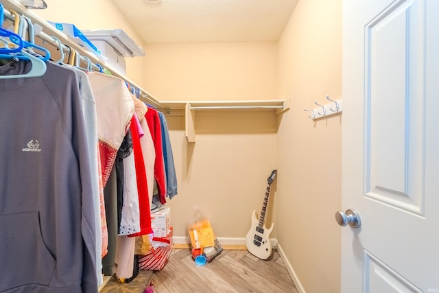 walk in closet featuring light hardwood / wood-style flooring