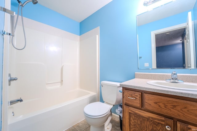 full bathroom featuring washtub / shower combination, tile patterned floors, vanity, and toilet