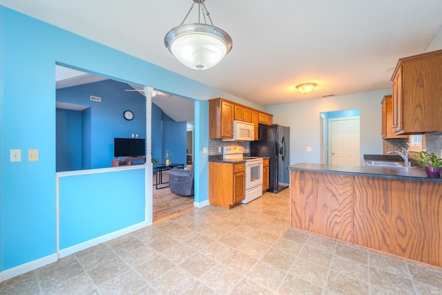 kitchen with tasteful backsplash, sink, hanging light fixtures, and white appliances