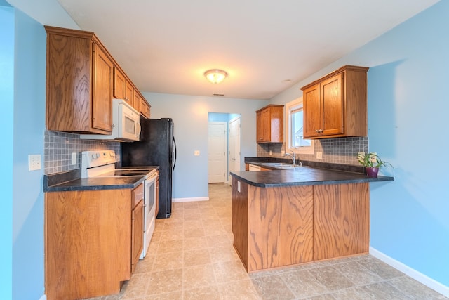 kitchen with decorative backsplash, kitchen peninsula, white appliances, sink, and light tile patterned floors