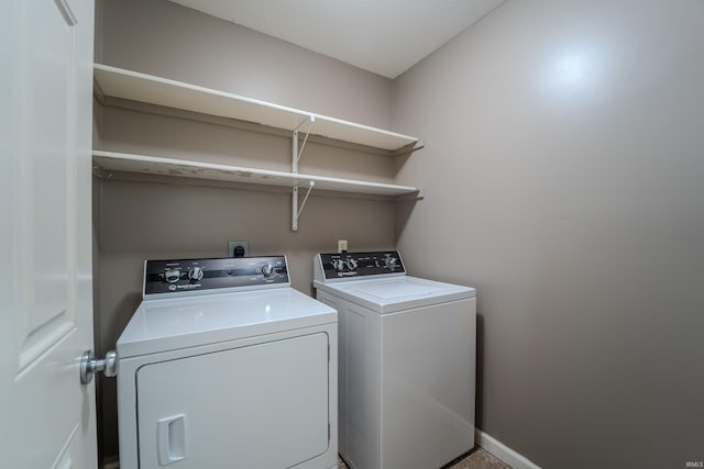 clothes washing area featuring washer and dryer