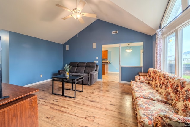 living room featuring ceiling fan, vaulted ceiling, and light hardwood / wood-style flooring