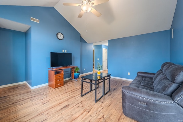 living room with ceiling fan, light hardwood / wood-style floors, and lofted ceiling