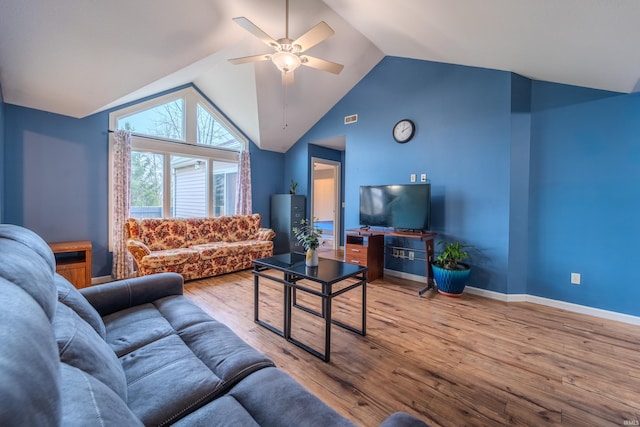 living room with ceiling fan, light hardwood / wood-style flooring, and vaulted ceiling