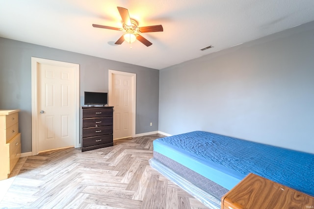 bedroom with ceiling fan and light parquet flooring