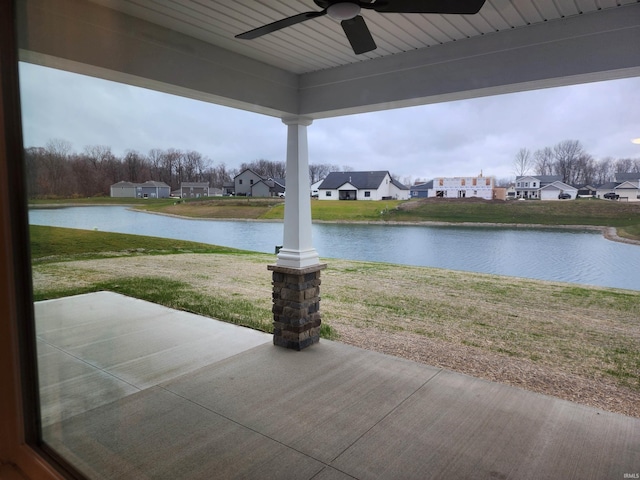 view of patio / terrace with ceiling fan and a water view