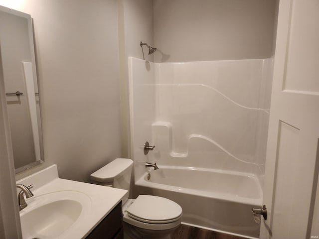 full bathroom featuring bathing tub / shower combination, vanity, hardwood / wood-style flooring, and toilet