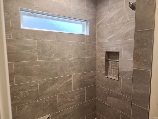 bathroom with a tile shower