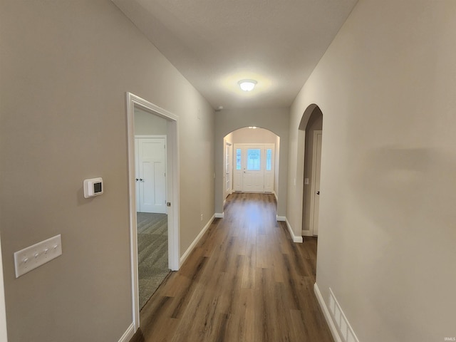 corridor featuring dark hardwood / wood-style flooring